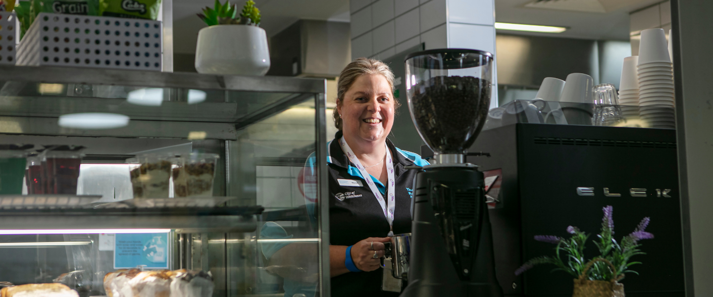 TRAC cafe and female staff member making coffee