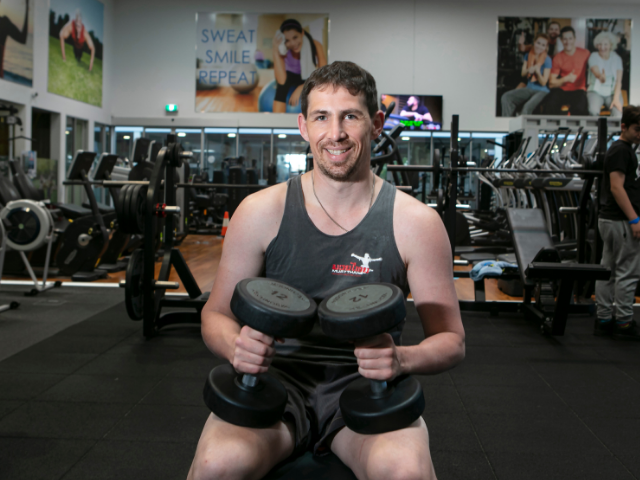 Man using weights in gym