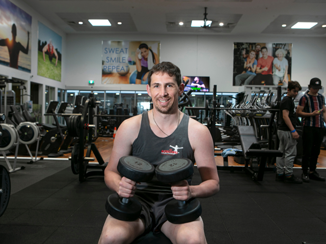 Man using weights in gym